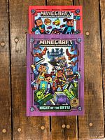 Front covers of both Minecraft Woodsword Chronicles hardcovers stacked