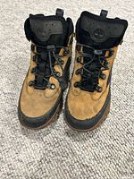 Front view of both boots showing uppers, laces, and toe condition