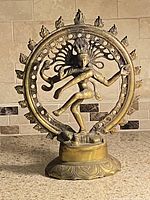Front view of brass/bronze Shiva Nataraja statue on countertop