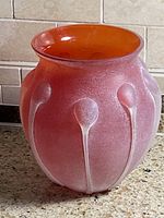 Full view of vase front showing frosted red exterior and applied white droplet ribs