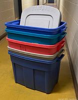 Stacked view of five plastic totes showing colours and one grey lid