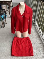 Jacket displayed on mannequin with skirt laid flat showing full set