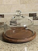 Glass dome on teak base front view
