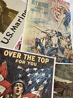 Group view of multiple WWI reproduction posters showing designs and size