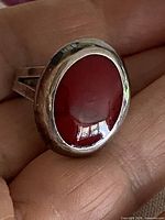 Top view showing oval red cabochon in silver bezel