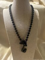 Full view of beaded necklace on bust form