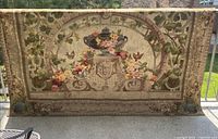 Front view of full tapestry showing urn and floral design
