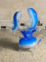 Full view of glass dolphin sculpture