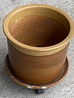 Top view of planter showing interior, rim color, attached saucer