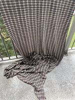 Full length of brown and cream plaid fabric draped to show width and texture