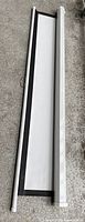 Screen retracted beside aluminum housing