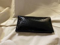 Front view of black patent leather croc-embossed long wallet