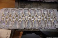 Row of teardrop chandelier crystals in packaging