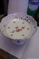 Front view of compote showing pierced rim and floral pattern