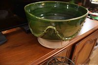 Overall view of green glazed terracotta planter on cabinet