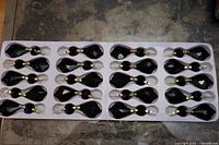 Tray holding 20 black chandelier drop crystals