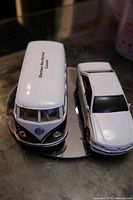 Top view of VW van beside Peugeot sedan showing scale and condition