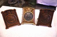 Front view of three medals showing material differences and inscriptions