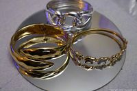 All three bracelets on mirrored surface