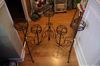 Overall view of folding metal plant stand fully opened