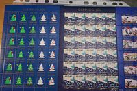 Left sheet with Christmas trees and snowmen, middle sailing ship sheet, partial third sheet