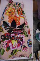 Front view showing floral print, logo and drawstring top