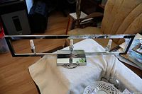 front view of chrome light fixture with three LED bulbs installed