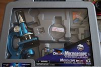 Front view of microscope kit in carry case showing microscope and accessories