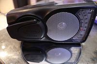 Front view showing speaker grille, crank handle folded, tuning window