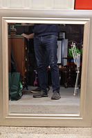 Front view of rectangular mirror showing silver frame and beveled glass