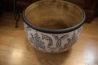 Side view showing white exterior with black paisley pattern and black rim