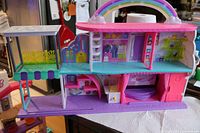 Front open view showing two levels, balcony, rainbow arch handle, interior rooms