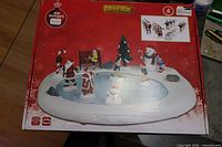 Front of Lemax Northern Lights Skating Pond box showing contents on base