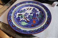 Full view of coloured Willow pattern plate