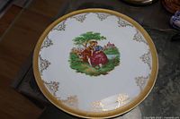 Full view of plate showing gold border and centre scene