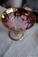 oblique view showing pink glass bowl, gold overlay, pedestal