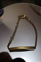Overall view of gold-tone bar bracelet with engraving