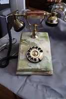 Full view of telephone showing onyx base, brass cradle and handset