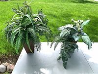 Both artificial arrangements on table outdoors