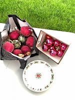 Overall lot view with glass baubles in box, glittered fruit in bag, holly plate