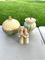 pineapple dish, fluted jar, and angel figurines grouped together