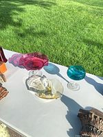 All three glass compotes displayed outdoors on table