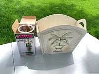Boxed wine cooler beside wooden palm holder, outdoor lighting