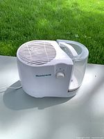 Front view of Honeywell humidifier showing control knob and tank