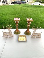 Two candlesticks, two wire reindeer, square tray displayed on table