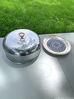 Cloche dome and decorative plate side by side on table