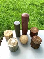 Group of seven assorted candles on table outdoors