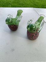 pair of glass bird figurines on table