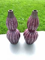 Front view of both ribbed purple ceramic vases