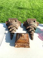Set showing two corbels and box on tabletop